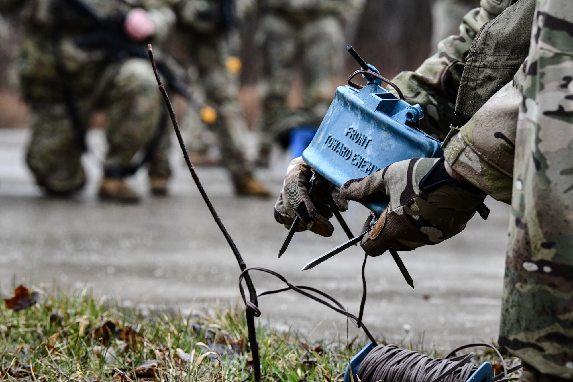 Senior Master Sgt. Jason Knepper, Air Force Reserve Command security forces training manager, demonstrates how to rig a claymore on March 17, 2023, at Camp James A. Garfield Joint Military Training Center, Ohio.