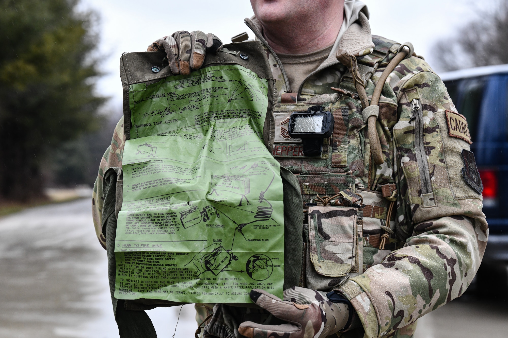 Senior Master Sgt. Jason Knepper, Air Force Reserve Command security forces training manager, demonstrates how to detonate a claymore on March 17, 2023, at Camp James A. Garfield Joint Military Training Center, Ohio.