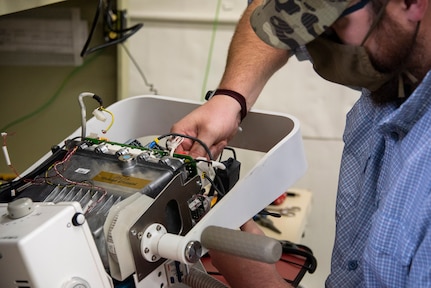 A biomedical equipment technician works on a portable X-ray machine at U.S. Army Medical Materiel Agency’s Medical Maintenance Operations Division at Tracy, California. (U.S. Army photo by Katie Ellis-Warfield/Released)