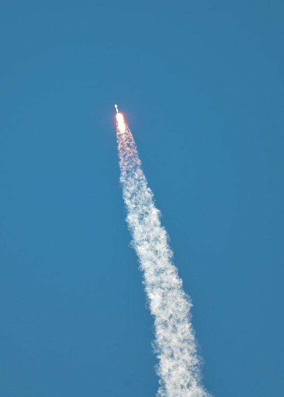 A rocket moves though the sky.