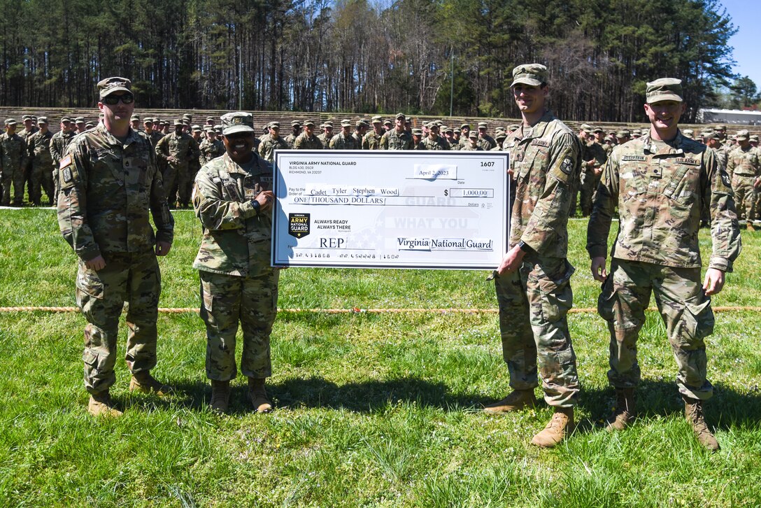 Cadet Tyler Wood receives a ceremony  for $1,000 as part of his participation in the Virginia National Guard’s Referral Enlistment Program April 2, 2023, at Fort Barfoot, Virginia, during Virginia Tech’s multi-day Field Training Exercise, or FTX. Maj. Kim Wynn, commander of the Virginia National Guard’s Recruiting and Retention Battalion and Virginia Tech alum, presented the check to Wood, and encouraged the cadets to participate in the REP and help grow the Virginia National Guard. Wood is a member of the Simultaneous Membership Program, or SMP, in which Soldiers serve in both the Virginia National Guard and their school’s ROTC program. Under the REP, Virginia citizens can earn $1,000 for providing qualified leads to the Virginia National Guard who ultimately enlist into the organization. Click here for more information on the REP: ngpa.us/22298 (U.S. Army National Guard photo by Sgt. 1st Class Terra C. Gatti)