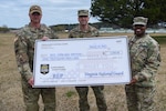 Sgt. Edward Hinton receives a ceremonial check for $1,000 as part of his participation in the Virginia National Guard’s Referral Enlistment Program March 18, 2023, at the State Military Reservation in Virginia Beach, Virginia. Lt. Col. Emily Huffman, SMR commander, and Maj. Kim Wynn, commander of the Virginia National Guard’s Recruiting and Retention Battalion, were on hand to congratulate and thank Hinton for helping grow the force. Hinton, assigned to SMR as an operations noncommissioned officer, worked with area recruiter Staff Sgt. Shawn Bartz to enlist a new recruit into the Virginia Army National Guard as a 09S Commissioned Officer Candidate. Hinton is the first participant to receive payment under the REP, which awards Virginia citizens $1,000 for providing qualified leads to the Virginia National Guard who enlist into the organization. (U.S. Army National Guard photo by Sgt. 1st Class Terra C. Gatti)