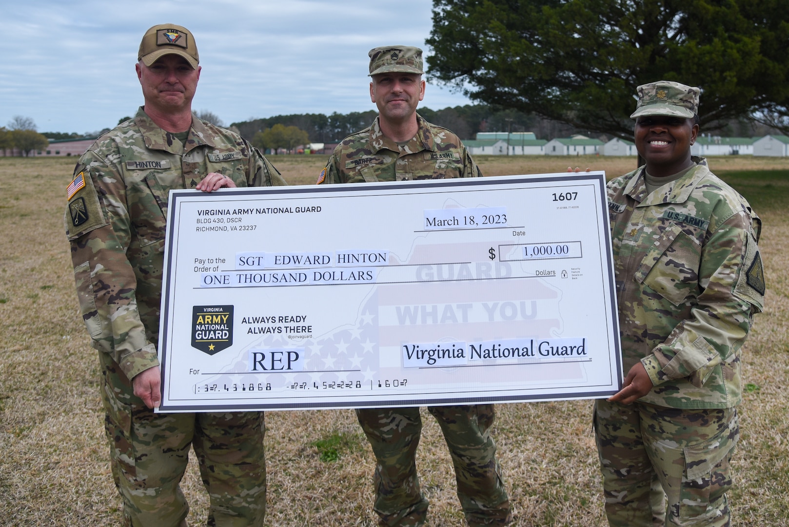 Sgt. Edward Hinton receives a ceremonial check for $1,000 as part of his participation in the Virginia National Guard’s Referral Enlistment Program March 18, 2023, at the State Military Reservation in Virginia Beach, Virginia. Lt. Col. Emily Huffman, SMR commander, and Maj. Kim Wynn, commander of the Virginia National Guard’s Recruiting and Retention Battalion, were on hand to congratulate and thank Hinton for helping grow the force. Hinton, assigned to SMR as an operations noncommissioned officer, worked with area recruiter Staff Sgt. Shawn Bartz to enlist a new recruit into the Virginia Army National Guard as a 09S Commissioned Officer Candidate. Hinton is the first participant to receive payment under the REP, which awards Virginia citizens $1,000 for providing qualified leads to the Virginia National Guard who enlist into the organization. (U.S. Army National Guard photo by Sgt. 1st Class Terra C. Gatti)