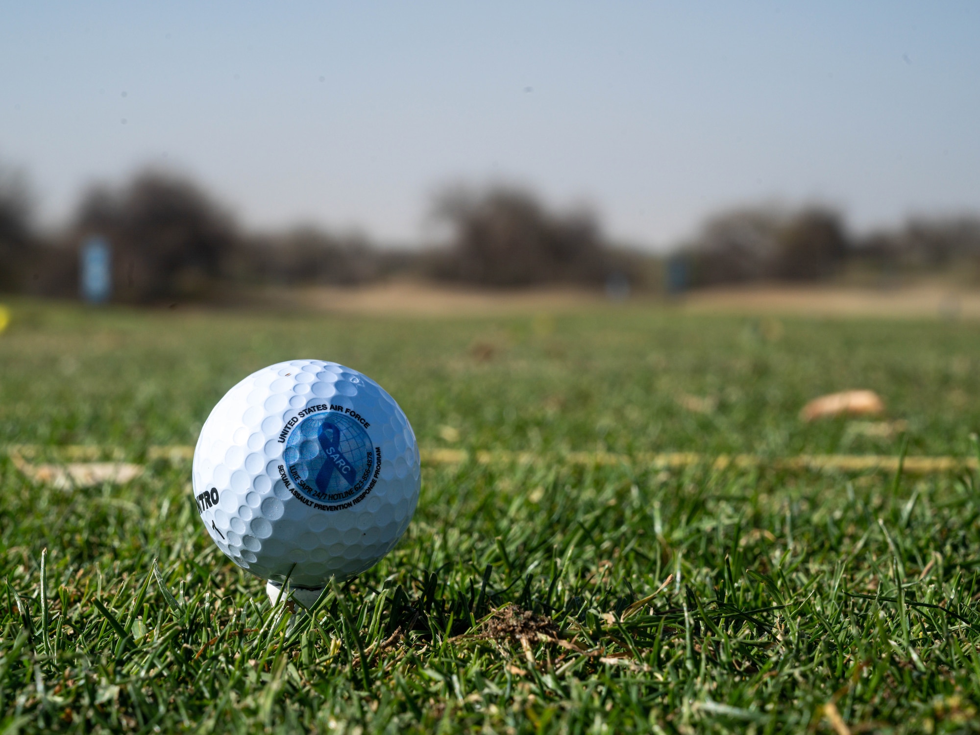 A custom golf ball lies teed up and ready for use during Luke Air Force Base’s Sexual Assault Awareness and Prevention Month event