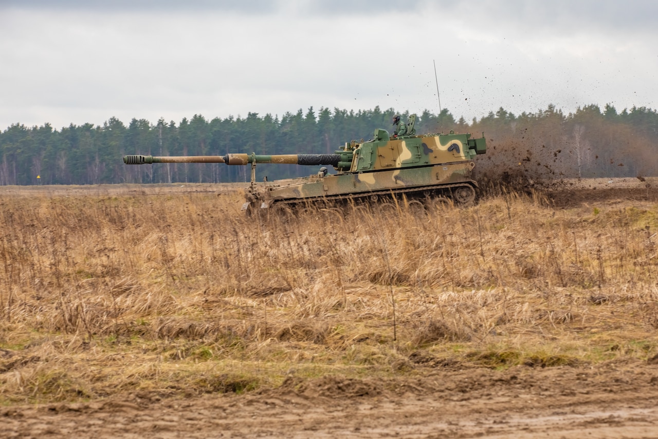 Tank cruises across terrain.