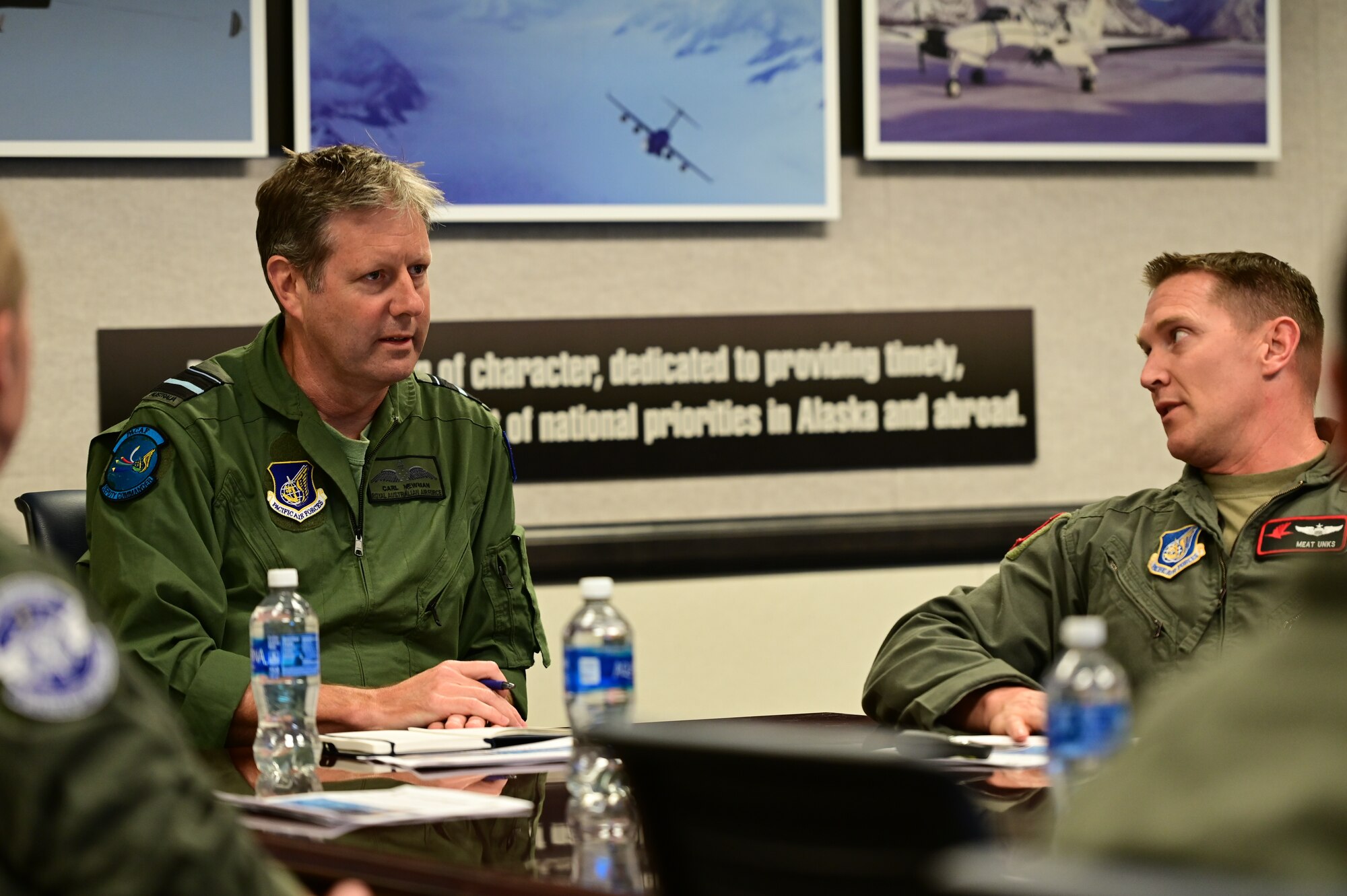 Royal Australian Air Force Air Vice-Marshal Carl Newman, Pacific Air Forces deputy commander, is briefed by Lt. Col. Kevin Unks, 517th Airlift Squadron director of operations, at Joint Base Elmendorf-Richardson, Alaska, March 28, 2023. Newman met with the 517th and the 144th AS command teams. Newman serving as the Pacific Air Forces deputy commander demonstrates a steadfast commitment between the U.S. and Australia. (U.S. Air Force photo by Airman 1st Class Quatasia Carter)