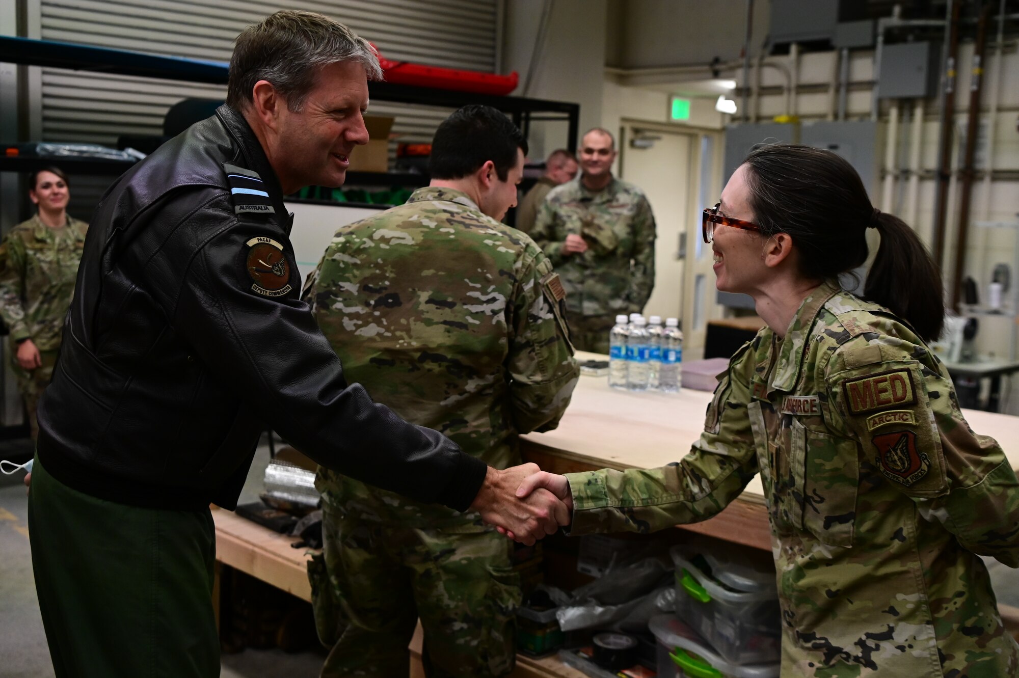 Royal Australian Air Force Air Vice-Marshal Carl Newman, Pacific Air Forces deputy commander, discusses the importance of health programs with leading officers of the 673d Medical Group at Joint Base Elmendorf-Richardson, Alaska, March 29, 2023. During the meeting, the 673d MDG presented Newman with informative slides on how mental health programs are actively supporting JBER’s Arctic Warriors. (U.S. Air Force photo by Airman 1st Class Quatasia Carter)