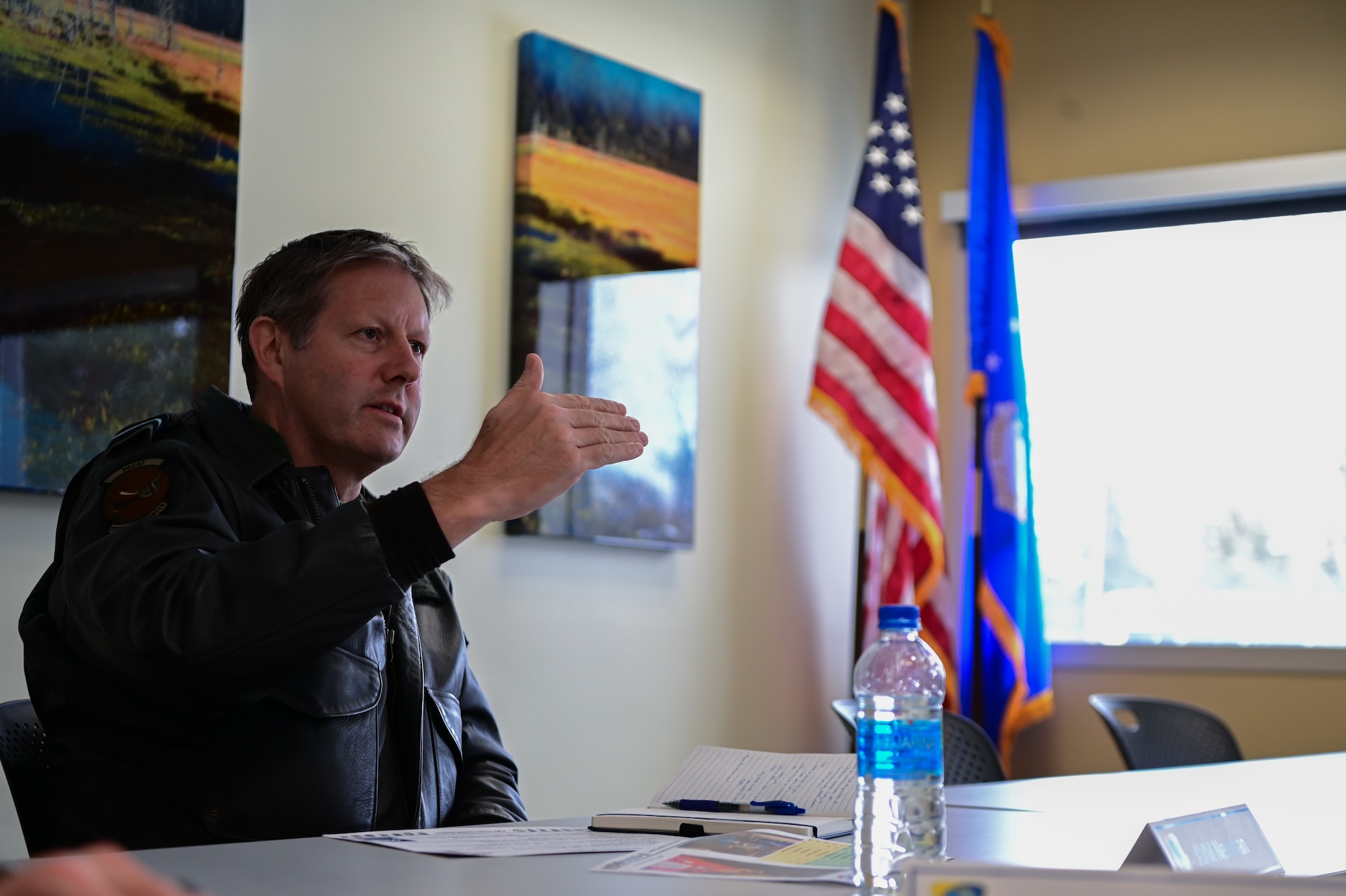 Royal Australian Air Force Air Vice-Marshal Carl Newman, Pacific Air Forces deputy commander, discusses the importance of health programs with leading officers of the 673d Medical Group at Joint Base Elmendorf-Richardson, Alaska, March 29, 2023. During the meeting, the 673d MDG presented Newman with informative slides on how mental health programs are actively supporting JBER’s Arctic Warriors. (U.S. Air Force photo by Airman 1st Class Quatasia Carter)