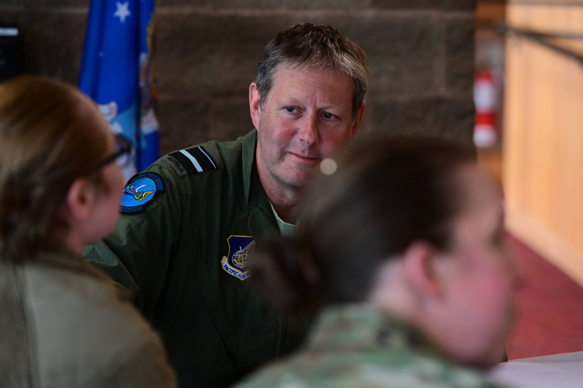 Royal Australian Air Force Air Vice-Marshal Carl Newman, Pacific Air Forces deputy commander, discusses the importance of health programs with leading officers of the 673d Medical Group at Joint Base Elmendorf-Richardson, Alaska, March 29, 2023. During the meeting, the 673d MDG presented Newman with informative slides on how mental health programs are actively supporting JBER’s Arctic Warriors. (U.S. Air Force photo by Airman 1st Class Quatasia Carter)