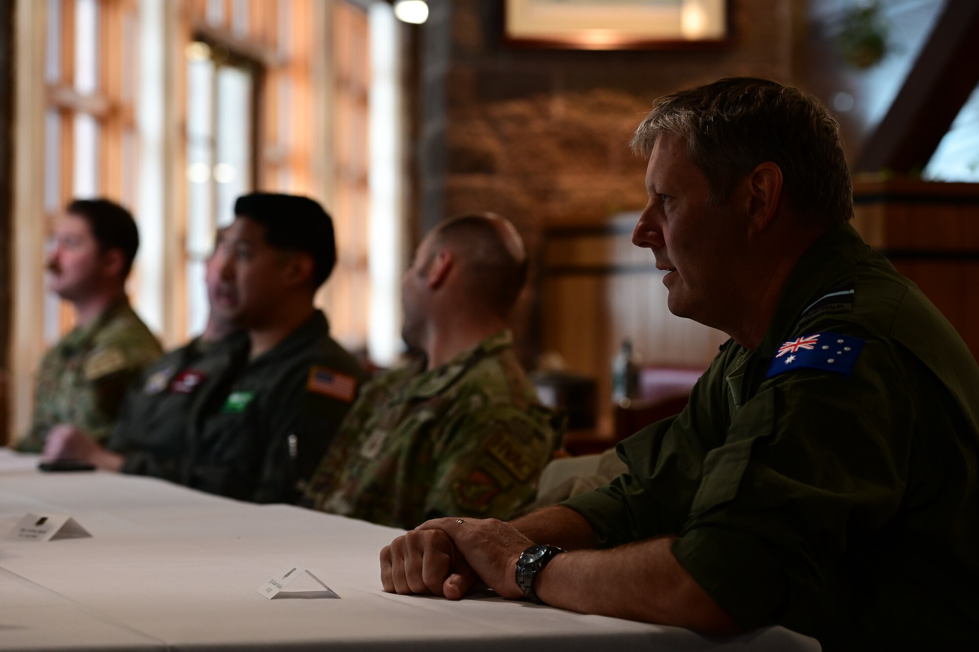 Royal Australian Air Force Air Vice-Marshal Carl Newman, Pacific Air Forces deputy commander, discusses the importance of health programs with leading officers of the 673d Medical Group at Joint Base Elmendorf-Richardson, Alaska, March 29, 2023. During the meeting, the 673d MDG presented Newman with informative slides on how mental health programs are actively supporting JBER’s Arctic Warriors. (U.S. Air Force photo by Airman 1st Class Quatasia Carter)