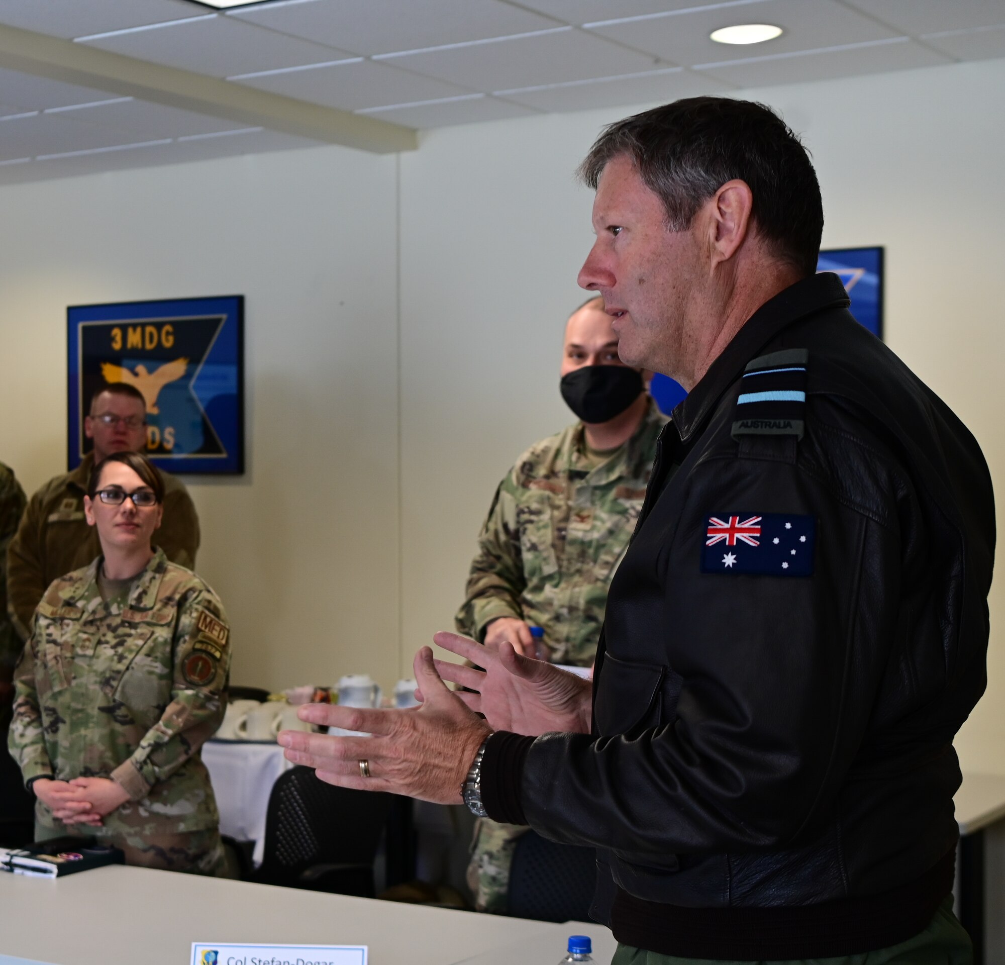 Royal Australian Air Force Air Vice-Marshal Carl Newman, Pacific Air Forces deputy commander, discusses the importance of health programs with leading officers of the 673d Medical Group at Joint Base Elmendorf-Richardson, Alaska, March 29, 2023. During the meeting, the 673d MDG presented Newman with informative slides on how mental health programs are actively supporting JBER’s Arctic Warriors. (U.S. Air Force photo by Airman 1st Class Quatasia Carter)