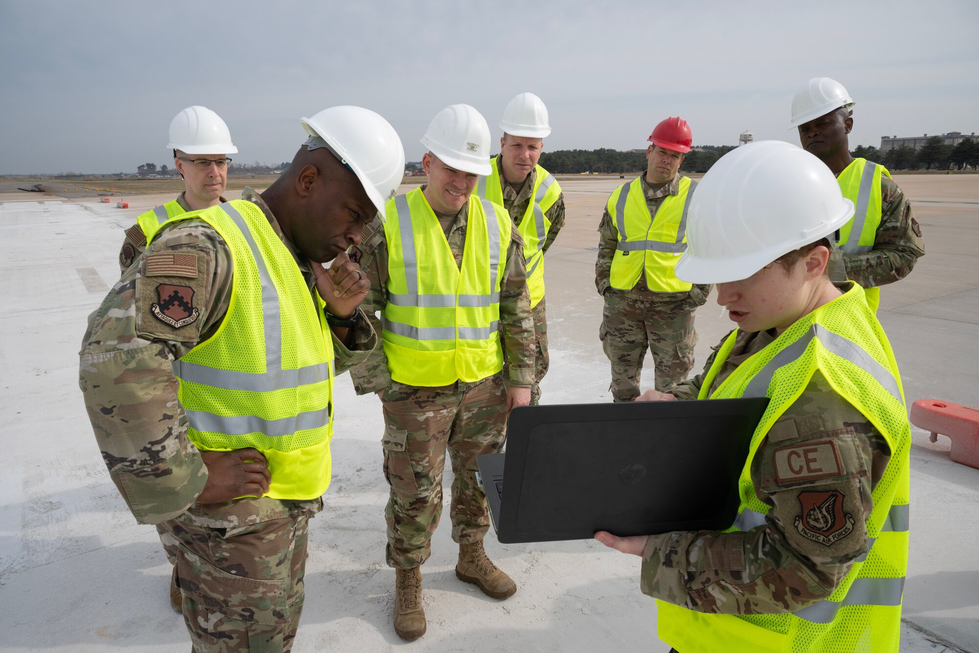 Airman leadership observe a laptop containing construction details.