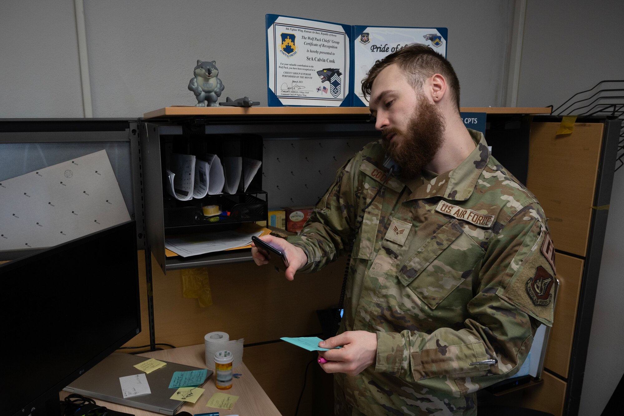 An Airman responds to a phone call.