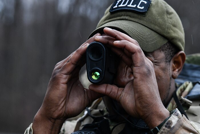 Staff Sgt. Daryn Weatherspoon, an Integrated Defense Leadership Course cadre member assigned to the 445th Security Forces Squadron, Wright-Patterson Air Force Base, Ohio, demonstrates how to use range estimation equipment on March 17, 2023, at Camp James A. Garfield Joint Military Training Center, Ohio.