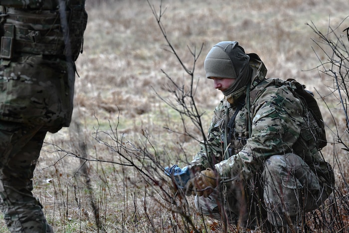 Tech. Sgt. Jason Barracato, a fireteam member assigned to the 459th Security Forces Squadron, Joint Base Andrews, Maryland, places a training claymore on March 17, 2023, at Camp James A. Garfield Joint Military Training Center, Ohio.