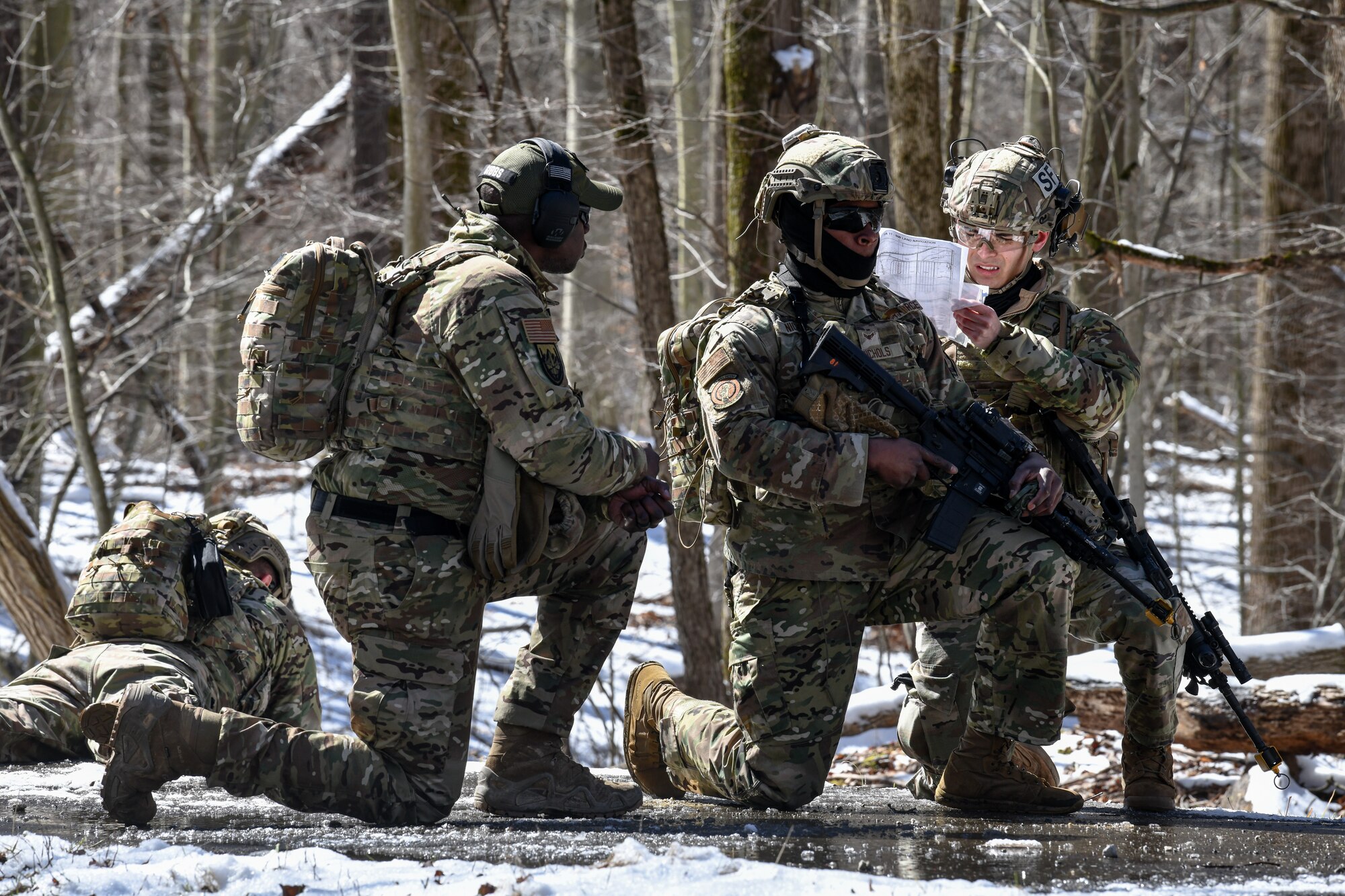 Airmen assigned to the 459th Security Forces Squadron, Joint Base Andrews, Maryland, use land navigation tools to calculate distance on March 15, 2023, at Camp James A. Garfield Joint Military Training Center, Ohio.