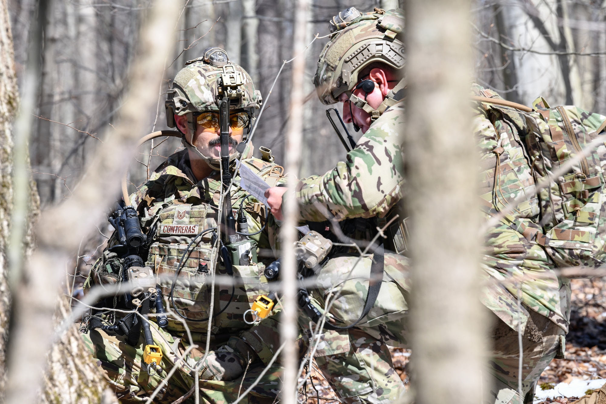 Tech. Sgts. Hanlet Contreras and Josue Cruz, fireteam members assigned to the 459th Security Forces Squadron, Joint Base Andrews, Maryland, use land navigation tools on March 15, 2023, at Camp James A. Garfield Joint Military Training Center, Ohio.