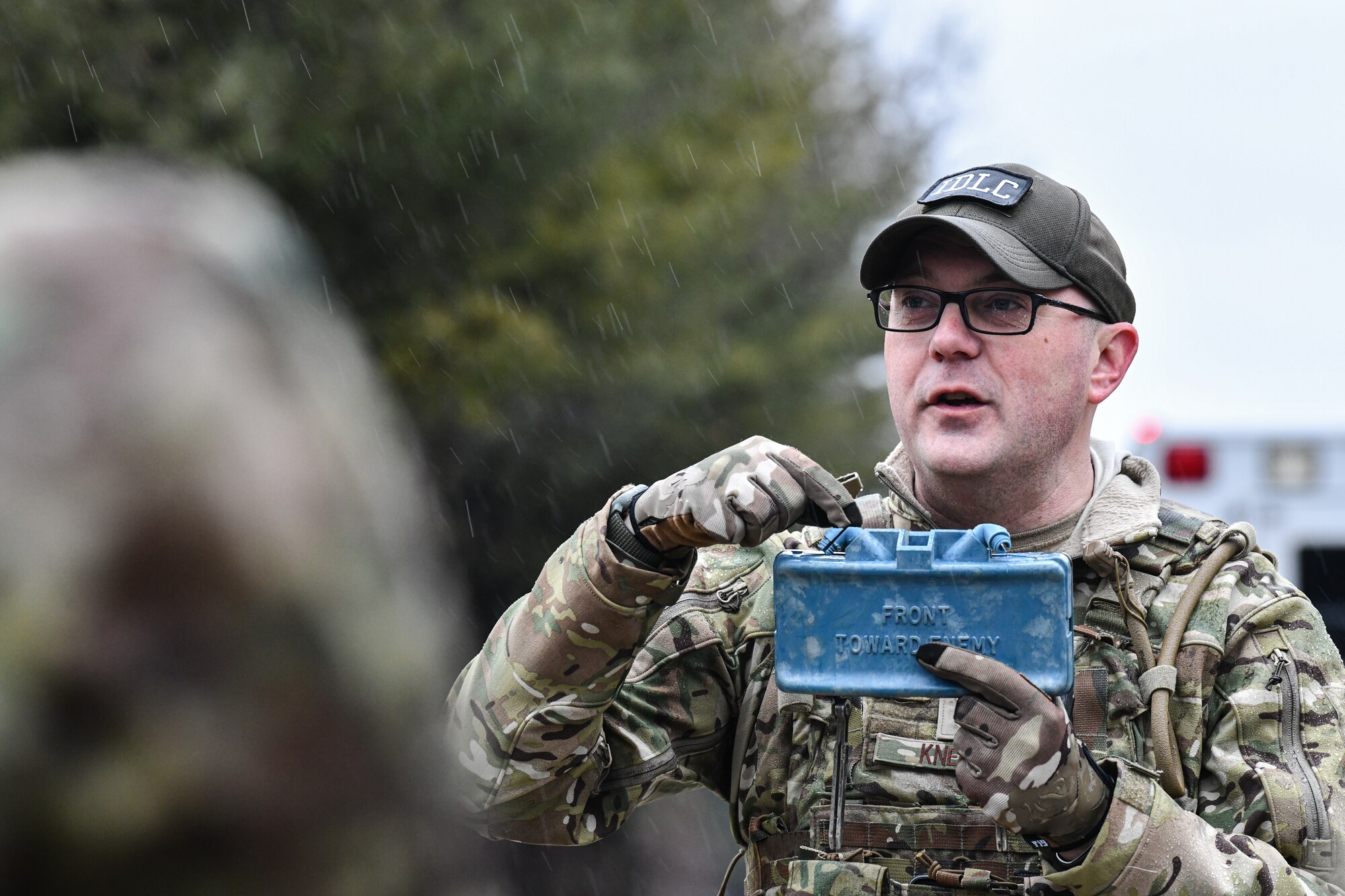 Senior Master Sgt. Jason Knepper, Air Force Reserve Command security forces training manager, demonstrates how to detonate a claymore on March 17, 2023, at Camp James A. Garfield Joint Military Training Center, Ohio.