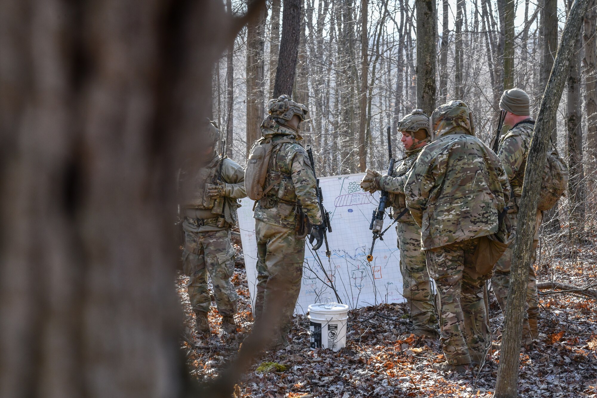 Reserve Citizen Airmen assigned to the 459th Security Forces Squadron, Joint Base Andrews, Maryland, communicate defense strategies on March 20, 2023, at Camp James A. Garfield Joint Military Training Center, Ohio.