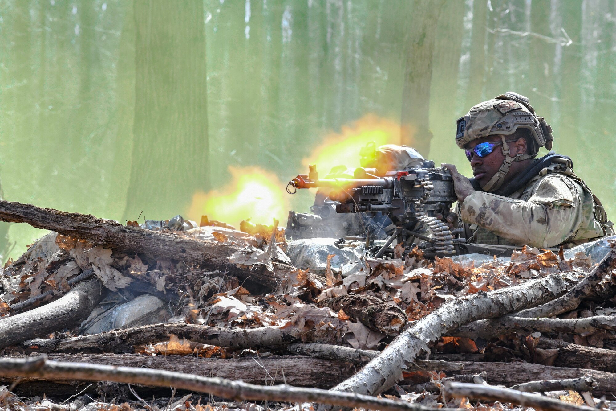Airman 1st Class Jhi Nichols, a fireteam member assigned to the 459th Security Forces Squadron, Joint Base Andrews, Maryland, fires a M240B machine gun at Camp James A. Garfield Joint Military Training Center, Ohio.
