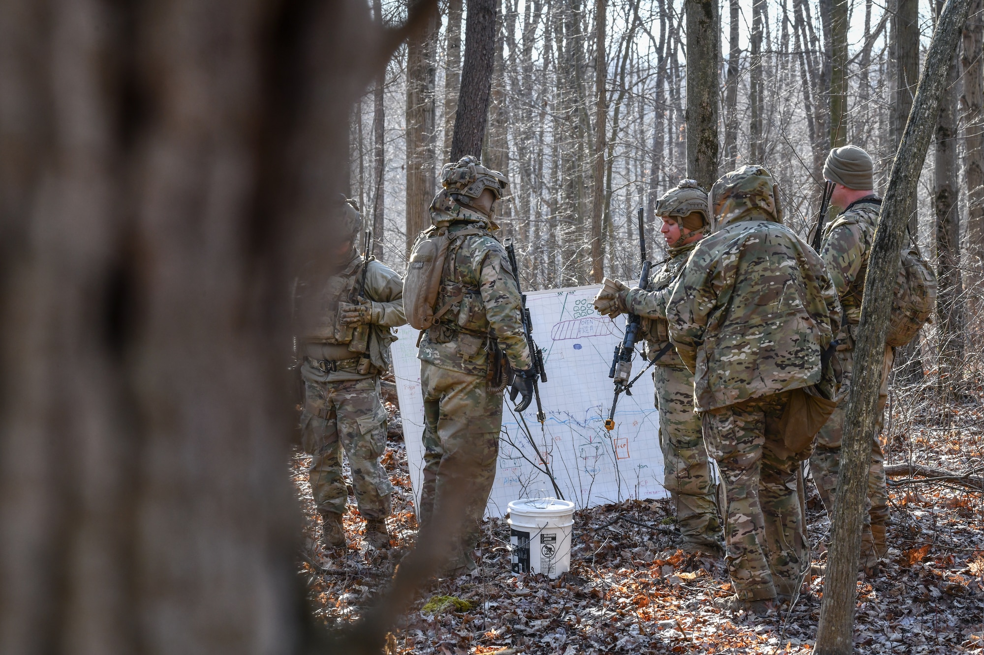 Reserve Citizen Airmen assigned to the 459th Security Forces Squadron, Joint Base Andrews, Maryland, communicate defense strategies on March 20, 2023, at Camp James A. Garfield Joint Military Training Center, Ohio.