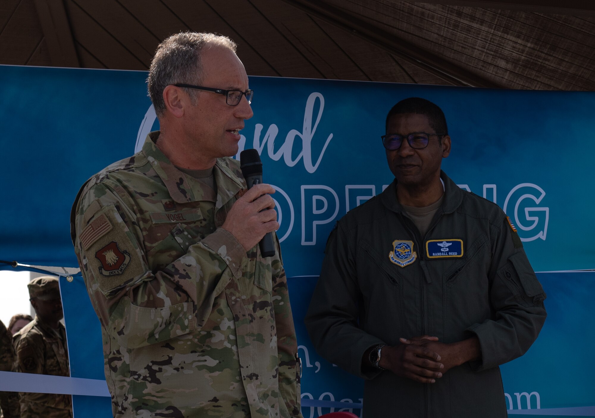 Col. Nate Vogel, 22nd Air Refueling Wing commander, gives opening remarks at the grand opening for the food truck park at McConnell Air Force Base, Kansas, April 4, 2023. The food truck park provides a variety of easily accessible food for Team McConnell servicemembers. The area was designated a no hat, no salute area for the grand opening. (U.S. Air Force photo by Staff Sgt. Tryphena Mayhugh)