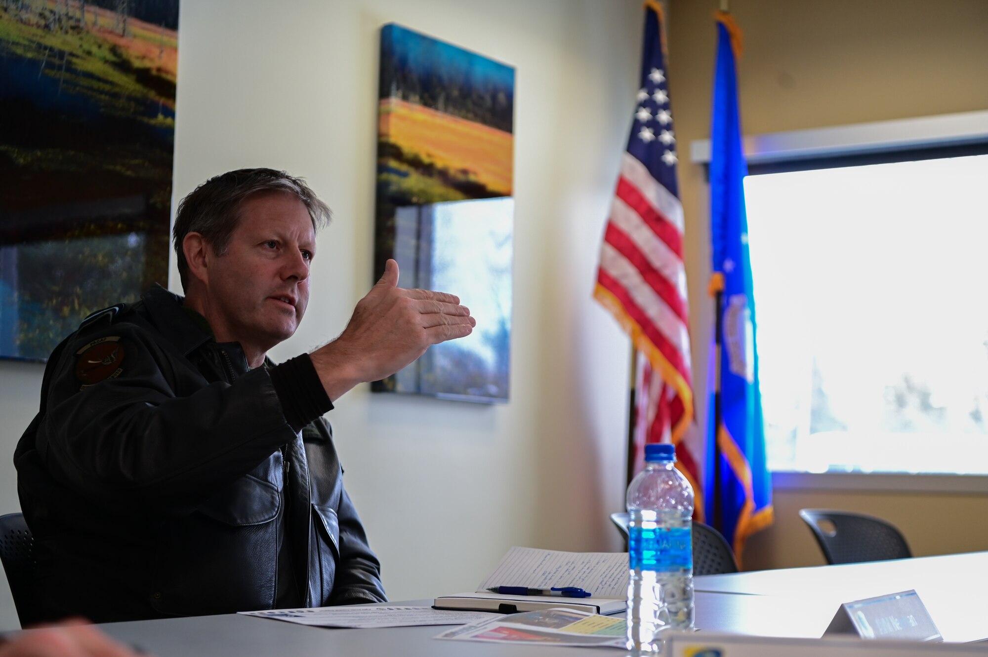 Royal Australian Air Force Air Vice-Marshal Carl Newman, Pacific Air Forces deputy commander, discusses the importance of health programs with leading officers of the 673d Medical Group at Joint Base Elmendorf-Richardson, Alaska, March 29, 2023. During the meeting, the 673d MDG presented Newman with informative slides on how mental health programs are actively supporting JBER’s Arctic Warriors. (U.S. Air Force photo by Airman 1st Class Quatasia Carter)