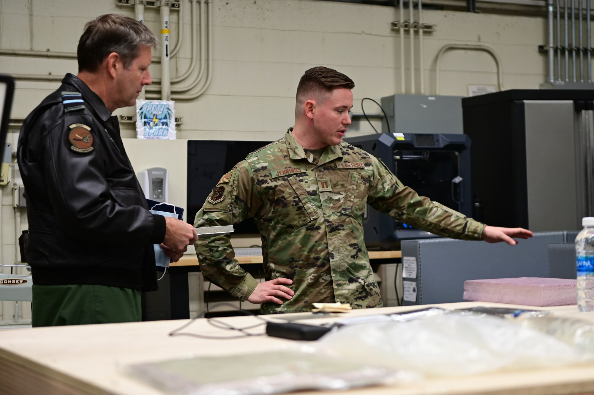 Royal Australian Air Force Air Vice-Marshal Carl Newman, Pacific Air Forces deputy commander, discusses the importance of health programs with leading officers of the 673d Medical Group at Joint Base Elmendorf-Richardson, Alaska, March 29, 2023. During the meeting, the 673d MDG presented Newman with informative slides on how mental health programs are actively supporting JBER’s Arctic Warriors. (U.S. Air Force photo by Airman 1st Class Quatasia Carter)