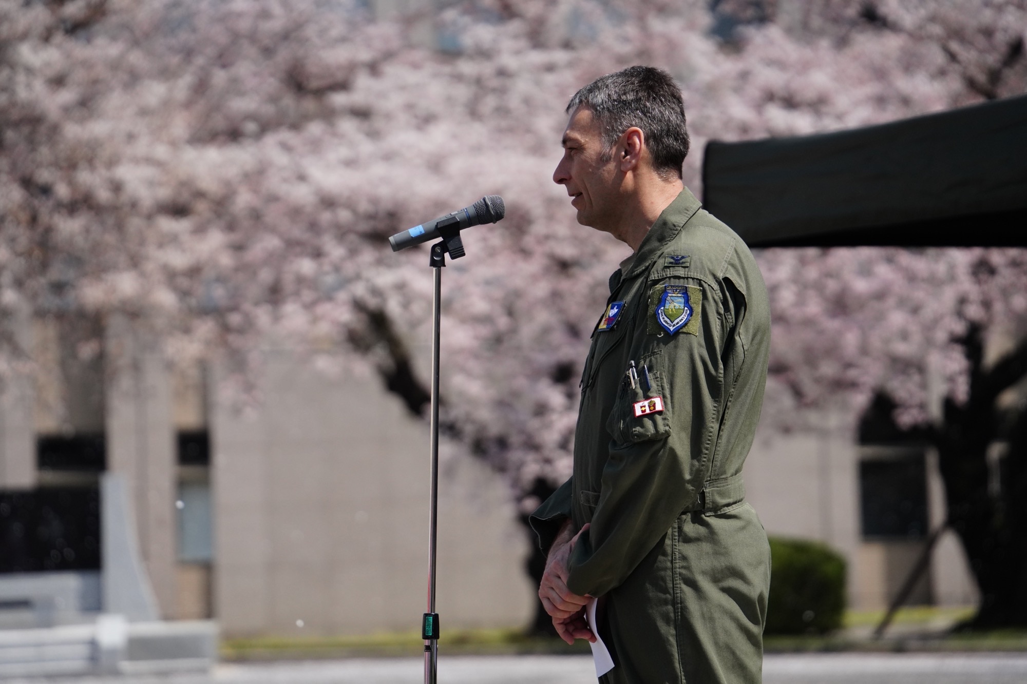 U.S. Air Force Col. Andrew Roddan, 374th Airlift Wing commander, speaks to attendees of an annual sakura viewing hosted by the Japan Air Self-Defense Force Operations Support Wing, April 1, 2023, at Yokota Air Base, Japan.