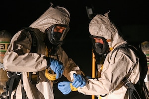 U.S. Air Force 2nd Lt. Austin Pero, 45th Operational Medical Readiness Squadron chief, occupational health element begins to tape all openings on a Chemical-resistant suit worn by U.S. Air Force Senior Airman Samantha Fox, Operational Medical Readiness Squadron bioenvironmental engineering technician on March 14, 2023 at Cape Canaveral Space Force Station, Fla. All openings are sealed so no potential chemicals can harm the wearer. (U.S. Space Force photo by Senior Airman Samuel Becker)