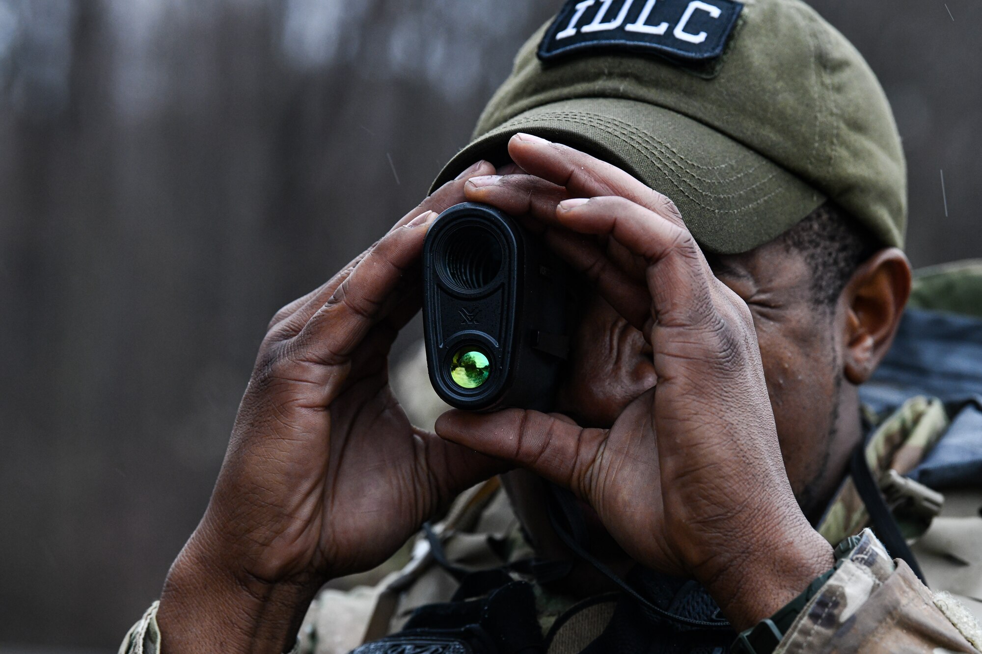 Staff Sgt. Daryn Weatherspoon, an Integrated Defense Leadership Course cadre member assigned to the 445th Security Forces Squadron, Wright-Patterson Air Force Base, Ohio, demonstrates how to use range estimation equipment on March 17, 2023, at Camp James A. Garfield Joint Military Training Center, Ohio.