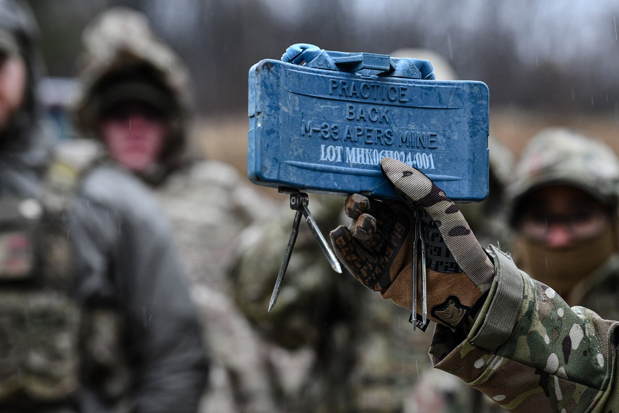 Senior Master Sgt. Jason Knepper, Air Force Reserve Command security forces training manager, demonstrates how to detonate a claymore on March 17, 2023, at Camp James A. Garfield Joint Military Training Center, Ohio.