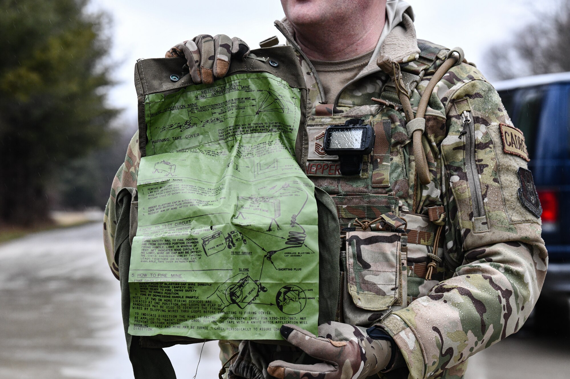 Senior Master Sgt. Jason Knepper, Air Force Reserve Command security forces training manager, demonstrates how to detonate a claymore on March 17, 2023, at Camp James A. Garfield Joint Military Training Center, Ohio.