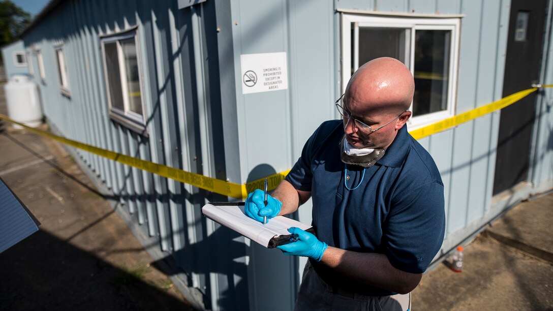 CID Agent takes notes at training crime scene.