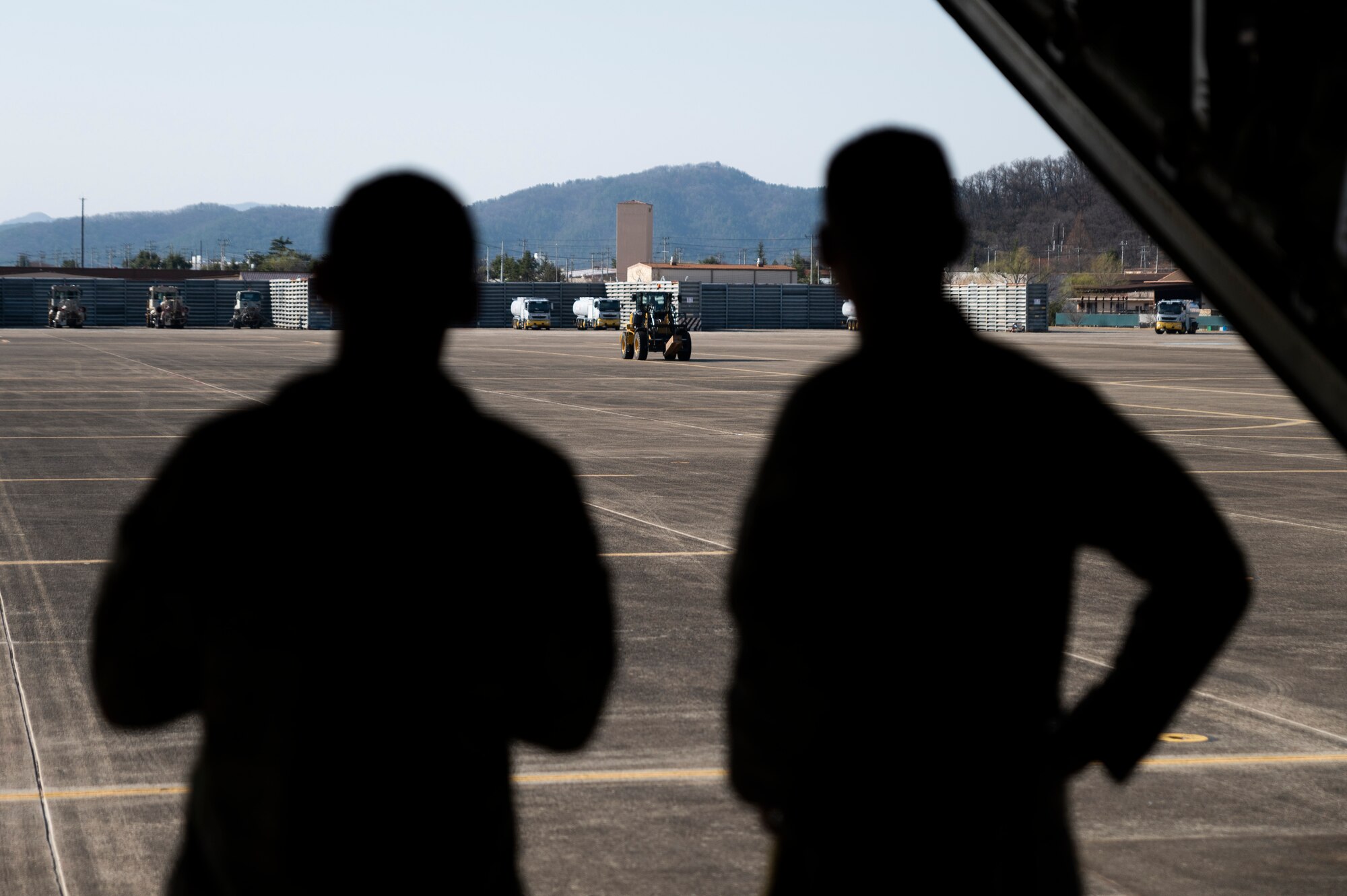 U.S. Airmen assigned to the 1st Special Operations Squadron wait for cargo to load onto an MC-130J Commando II in preparation for Freedom Shield 23 at Daegu Air Base, Republic of Korea, Mar. 13, 2023.