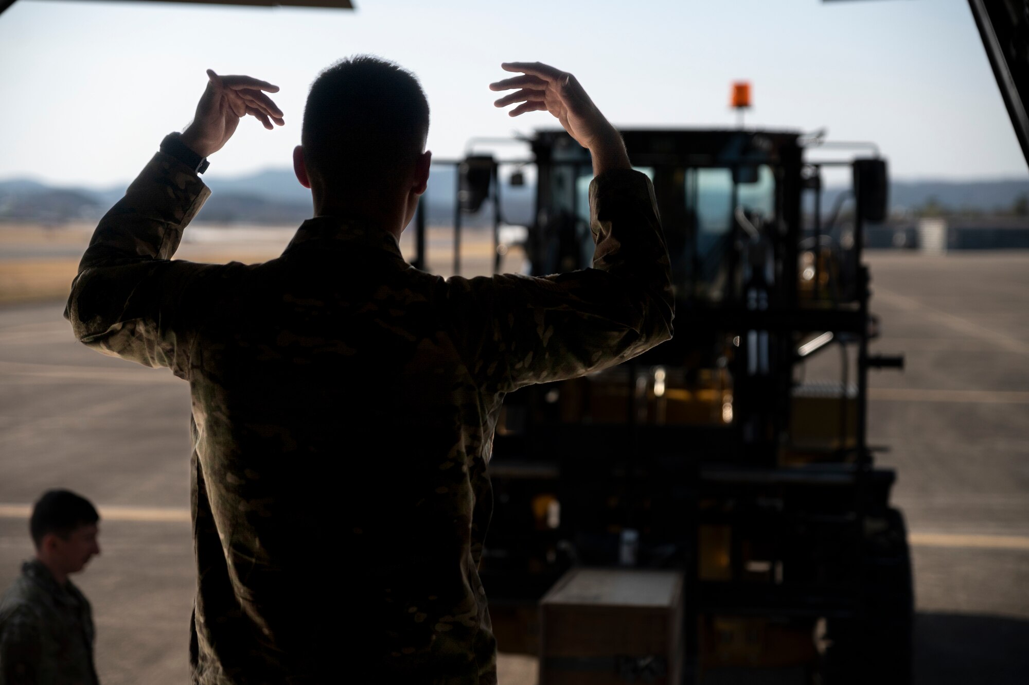 U.S. Airman assigned to the 1st Special Operations Squadron guides cargo onto an aircraft in preparation of Freedom Shield 23 at Daegu Air Base, Republic of Korea, Mar. 13, 2023.