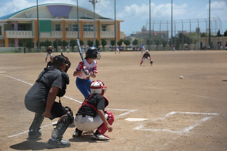 The American Legion Fast Pitch Softball team, comprised of dependents from across the SOFA community, plays against a combined local Junior High School team, a third ranked in Okinawa prefecture, in the fast-pitch softball game on Aril 2 to strengthening relationships with allies and partners.