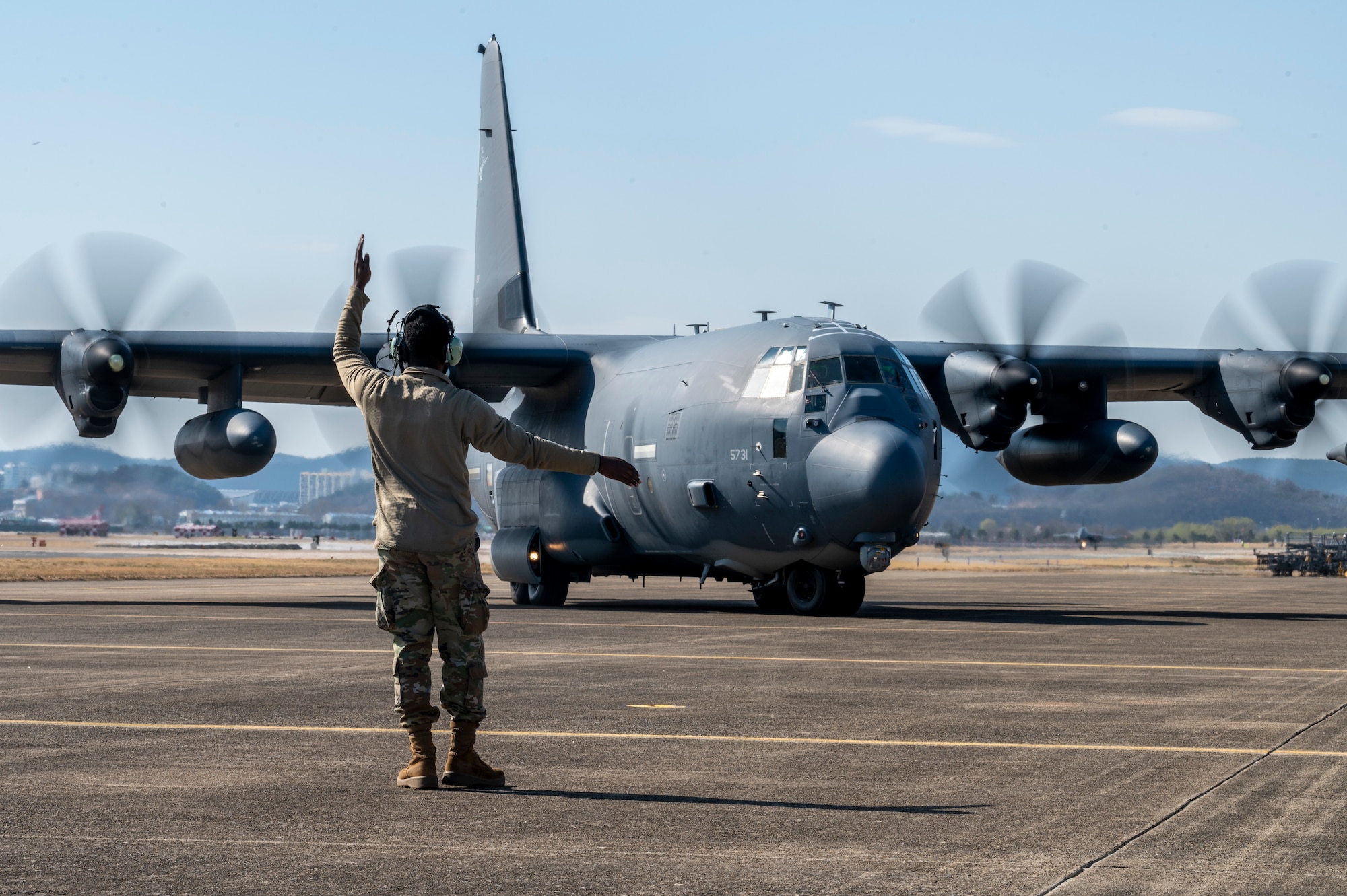 U.S. Airman assigned to the 353rd Special Operations Aircraft Maintenance Squadron guides an MC-130J Commando II during take-off procedures in support of Freedom Shield 23 at Daegu Air Base, Republic of Korea, Mar. 14, 2023.