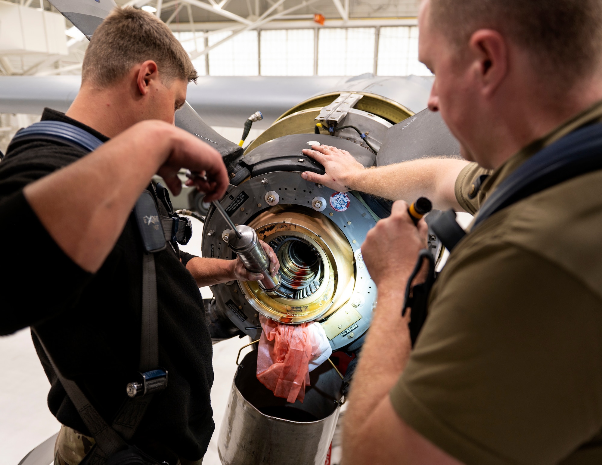 U.S. Air Force Airman 1st Class Jesse Carlson and U.S. Air Force Tech. Sgt. Luke Harren, 133rd Maintenance Squadron, removes hydraulic fluid in St. Paul, Minn., Oct. 24, 2022.