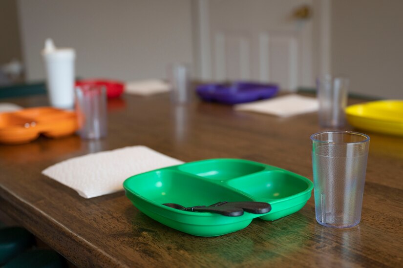 Child-sized dining utensils are set for lunch in a Family Child Care provider’s home on March 31, 2023, at Joint Base Anacostia-Bolling, Washington, D.C. Cooking equipment, sleeping cots, baby gates, toys for all ages and many other resources are supplied to FCC providers to support their child care needs. (U.S. Air Force photo by Jason Treffry)