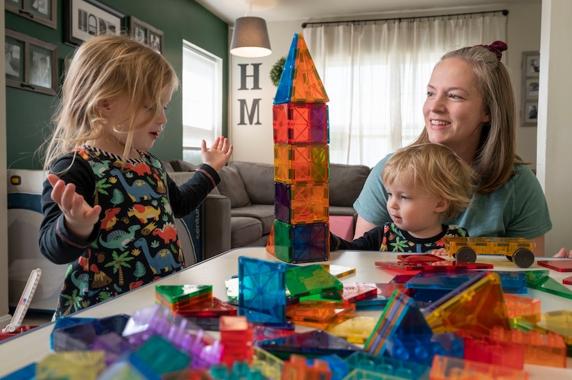 Morgan and Bruce Wade play with their mom, Amanda Wade, in their home on March 31, 2023, at Joint Base Anacostia-Bolling, Washington, D.C. Amanda Wade and other licensed Family Child Care providers are authorized and financially compensated to care for up to six children, including their own. (U.S. Air Force photo by Jason Treffry)