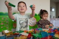 Augusto Hernandez, left, and Bella Braden, play with toys in a Family Child Care provider’s home on March 31, 2023, at Joint Base Anacostia-Bolling, Washington, D.C. Cooking equipment, sleeping cots, baby gates, toys for all ages and many other resources are supplied to FCC providers to support their child care needs. (U.S. Air Force photo by Jason Treffry)
