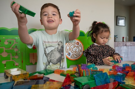 Augusto Hernandez, left, and Bella Braden, play with toys in a Family Child Care provider’s home on March 31, 2023, at Joint Base Anacostia-Bolling, Washington, D.C. Cooking equipment, sleeping cots, baby gates, toys for all ages and many other resources are supplied to FCC providers to support their child care needs. (U.S. Air Force photo by Jason Treffry)