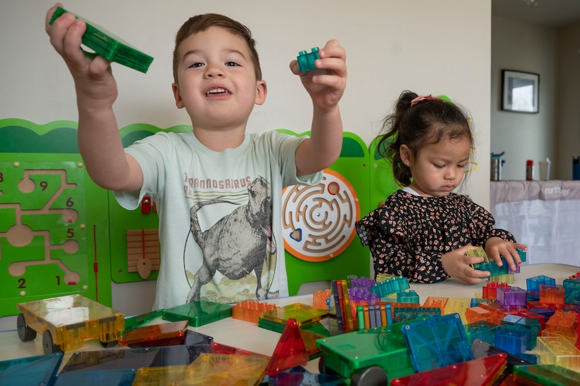 Augusto Hernandez, left, and Bella Braden, play with toys in a Family Child Care provider’s home on March 31, 2023, at Joint Base Anacostia-Bolling, Washington, D.C. Cooking equipment, sleeping cots, baby gates, toys for all ages and many other resources are supplied to FCC providers to support their child care needs. (U.S. Air Force photo by Jason Treffry)