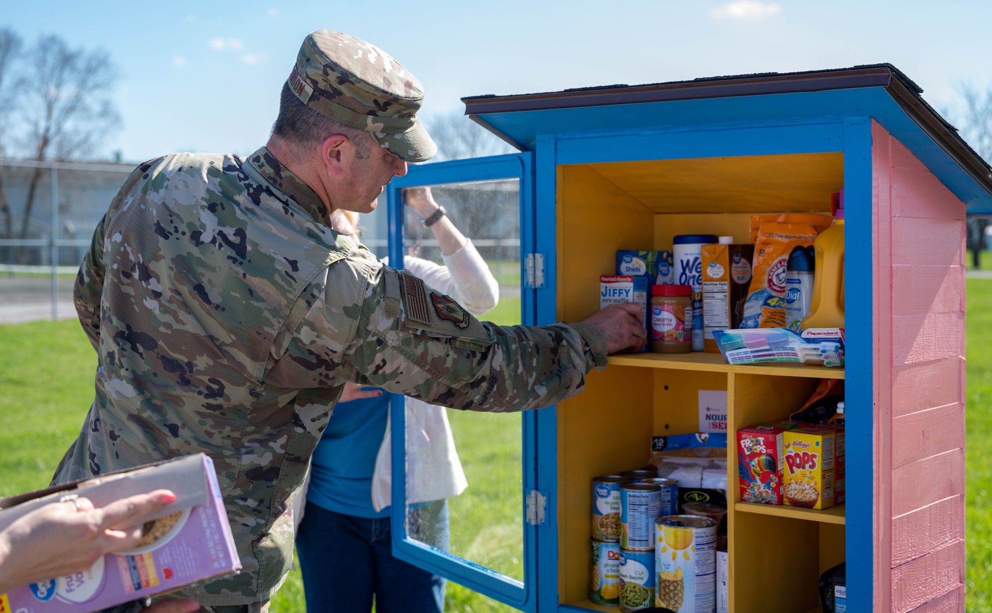 Airman filling box with food