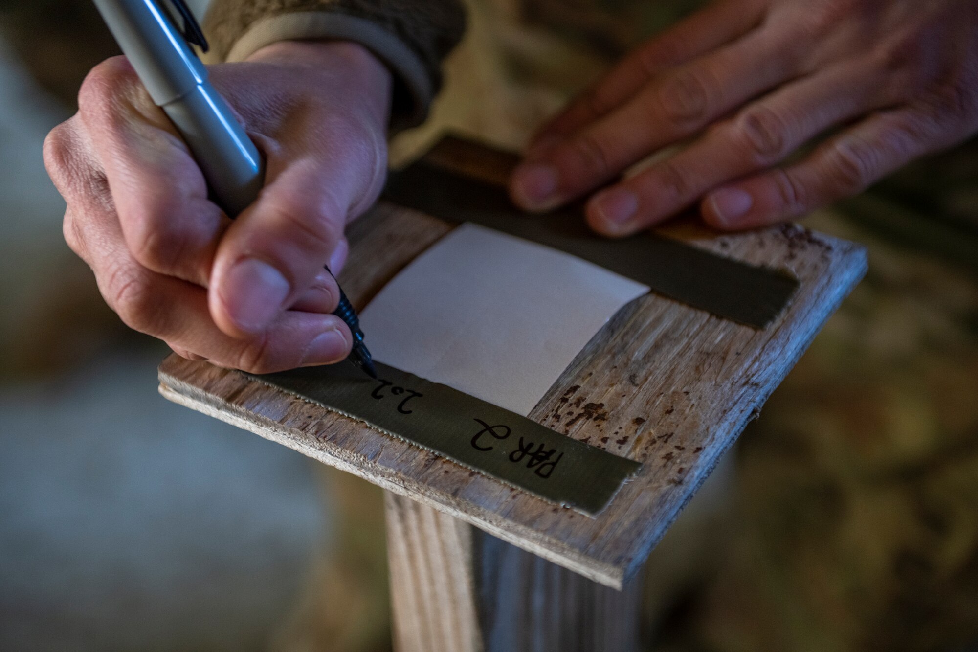 U.S. Air Force Airman 1st Class Matthew McIlroy assigned to the 23rd Maintenance Group prepares a post-attack reconnaissance stand