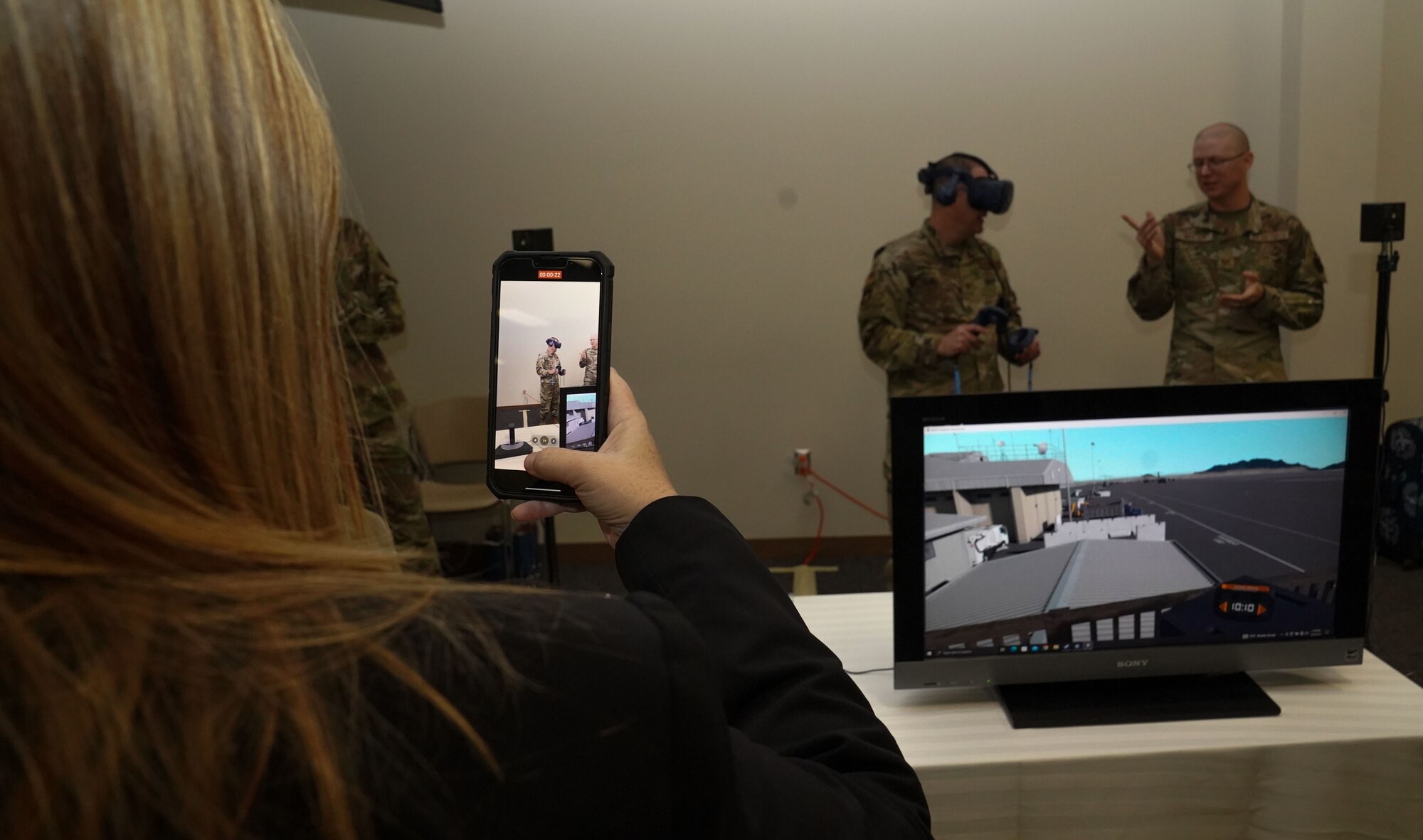 Sabrina Booker, Second Air Force training pathway manager, films a virtual reality demonstration at the Technical Training 101 Tech Expo at Keesler Air Force Base, Mississippi, March 30, 2023.
