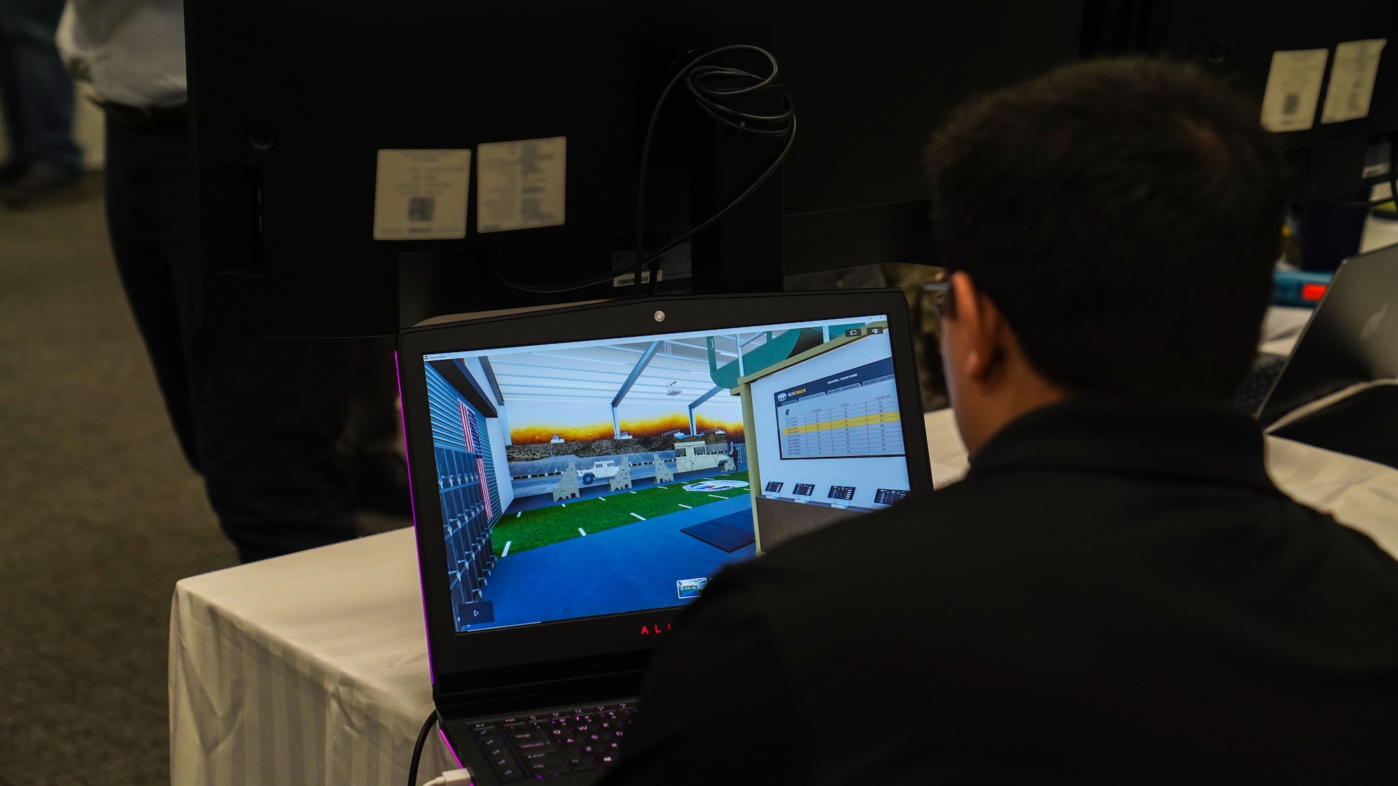 Daniel Bustos, Improve Group architectural designer, works on a model training area for pararescue Airmen at the Technical Training 101 Tech Expo on Keesler Air Force Base, Mississippi, March 30, 2023.