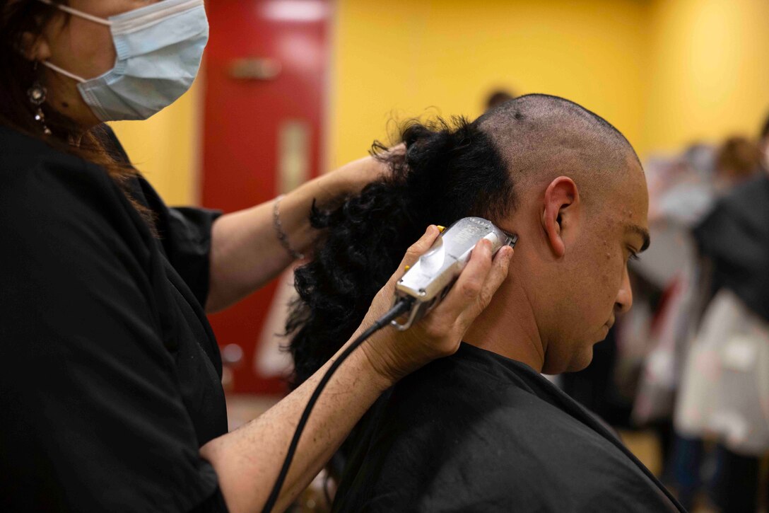 A recruit receives a haircut.