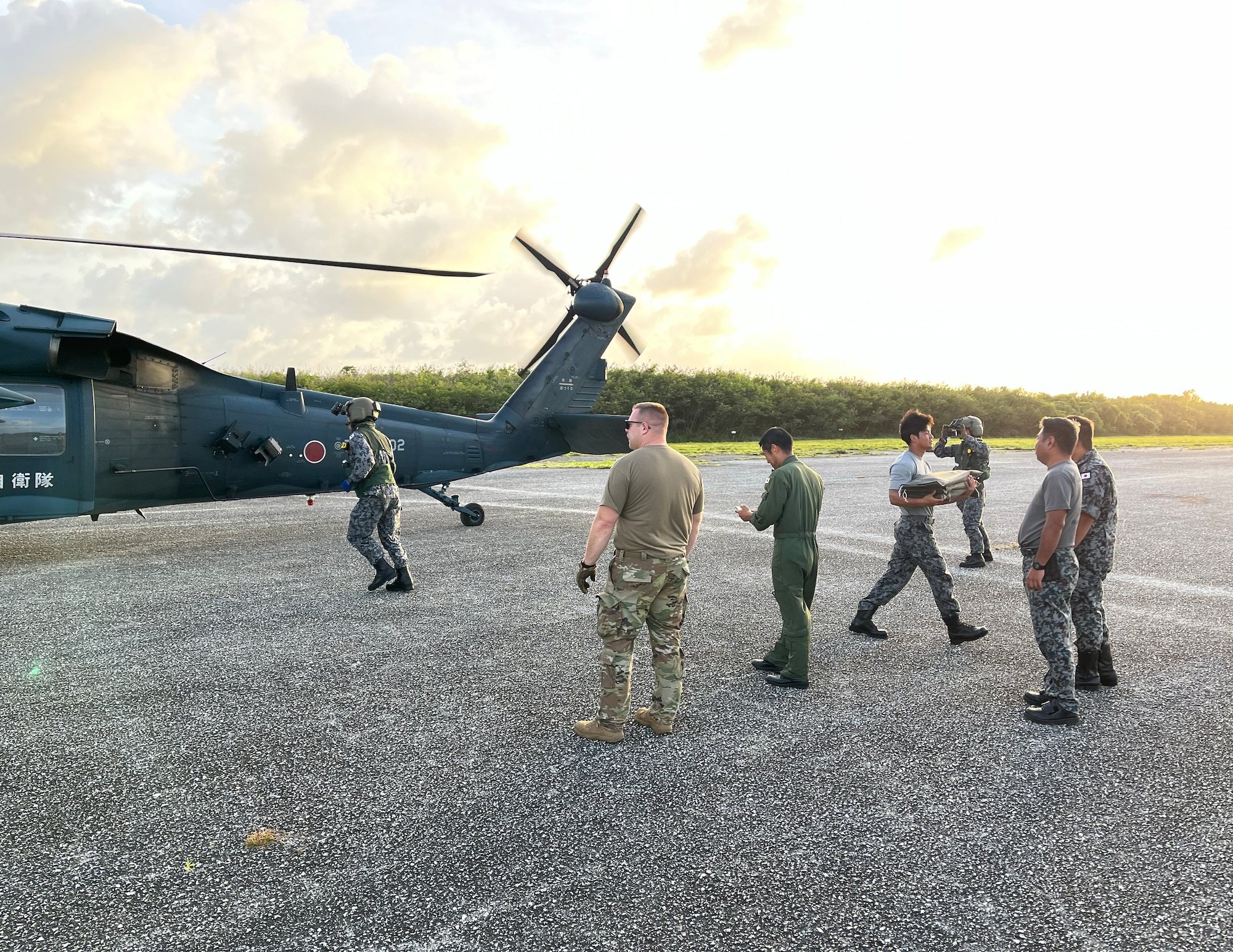 U.S. Air Force Tech. Sgt. Michael Schuette, 133rd Contingency Response Team, offloads supplies from a Japanese UH-60 in the Commonwealth of the Northern Marianas Islands, Feb. 13, 2023.